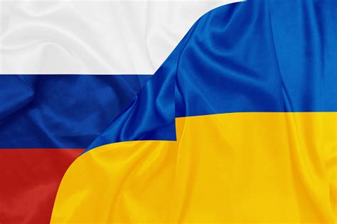 Russia And Ukraine National Flags On Silk Texture Stock Photo - Download Image Now - iStock