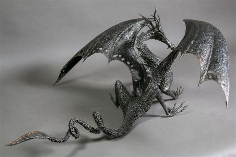 Black metal dragon sculpture with wings