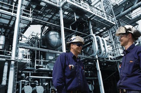 Oil and gas workers inside refinery industry Stock Photo by ©lagereek 104466846