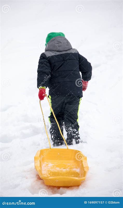 Child Pulling Sled in the Snow Stock Image - Image of winter, outdoors: 169097157