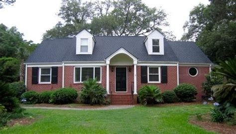 red brick house with metal roof - Hyo Elston