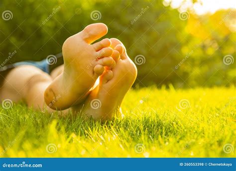 Teenage Girl Lying Barefoot on Green Grass Outdoors, Closeup. Space for Text Stock Photo - Image ...