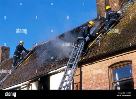 Firefighters at a house fire Stock Photo - Alamy