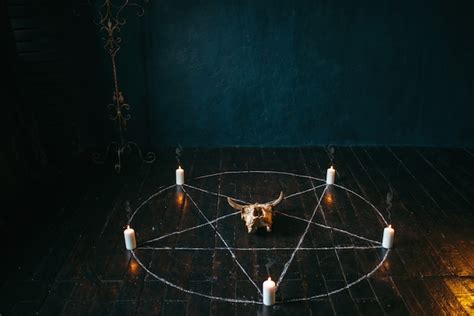 Premium Photo | Young demonic woman sitting near magic circle with candles, demons casting out ...