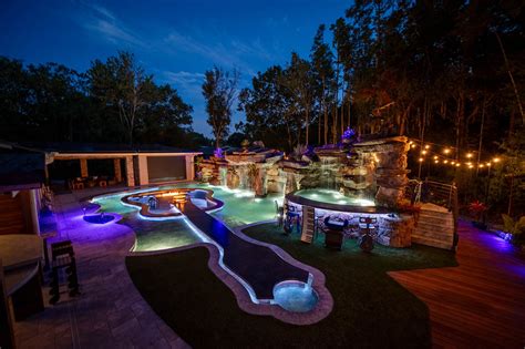 This Guitar Shaped Pool Features a Rock Waterfall and Swim-up Bar - Mad Mansions