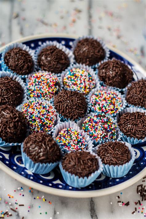 chocolate cupcakes with sprinkles in a blue and white plate on a marble table