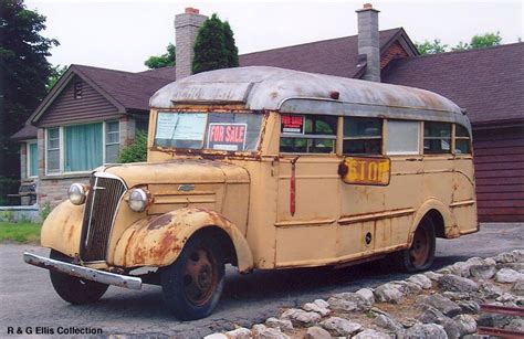 Old Yellow Bus Parked in Front of a House