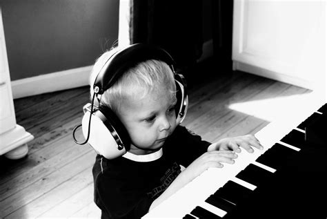 little boy playing piano Playing Piano, Boys Playing, Piano Lessons, Munchkin, Over Ear ...