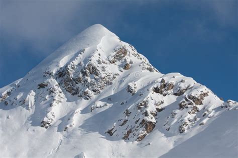 Snow covered mountain peak stock image. Image of mountain - 13135751