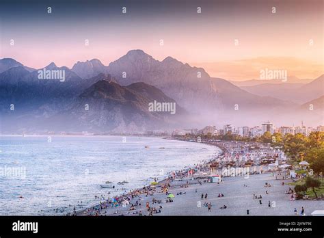 Sunset HDR effect view of scenic and popular Konyaalti beach in Antalya resort town. Majestic ...