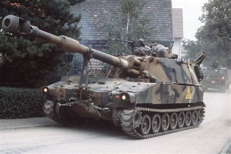 An M109A1 155 mm self-propelled Howitzer passes through the town of ...