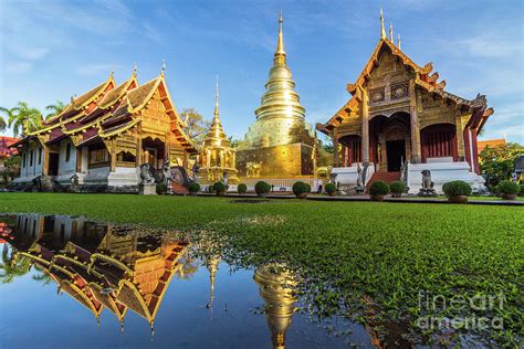 Wat Phra Singh temple, blue sky and reflection in water. Chiang Mai, Thailand. Photograph by ...