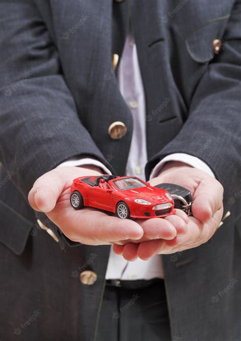 Premium Photo | Red car and key in seller's hand