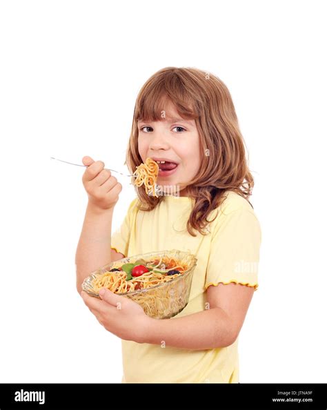 hungry little girl eat spaghetti Stock Photo - Alamy