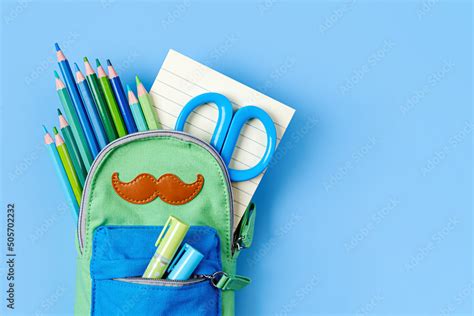 Opened Pencil case with stationery on blue background. Concept back to school. School supplies ...