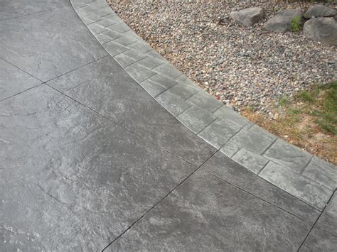 Black Stamped Concrete Driveway With Gray Borders