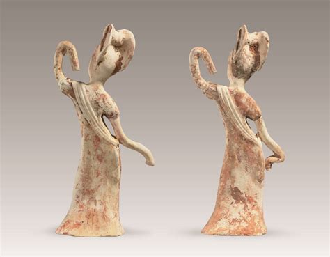 A PAIR OF PAINTED POTTERY FIGURES OF FEMALE DANCERS , TANG DYNASTY (AD 618-907) | Christie's