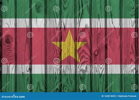 Suriname Flag Depicted in Bright Paint Colors on Old Wooden Wall. Textured Banner on Rough ...