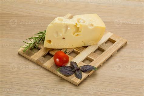 Maasdam cheese on wooden background 10906554 Stock Photo at Vecteezy