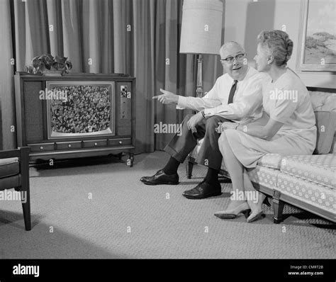 Mature couple sitting couch home talking Black and White Stock Photos & Images - Alamy