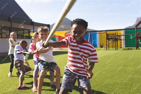 Premium Photo | Group of school kids playing tug of war