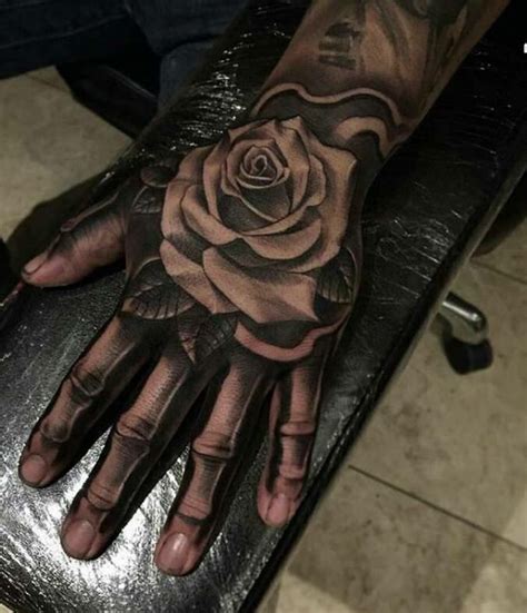 Rose on skeleton hand | Skull hand tattoo, Rose tattoos for men, Rose ...