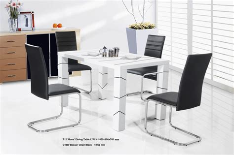a white table with four black chairs around it