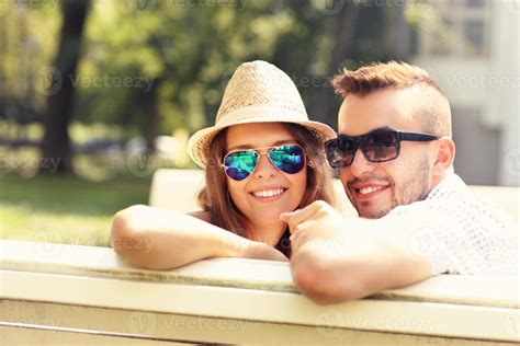 Lovely couple sitting on the bench 15895841 Stock Photo at Vecteezy