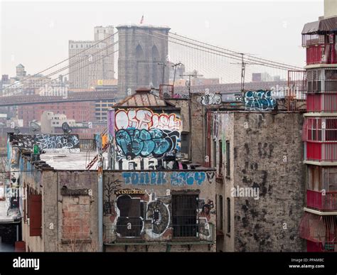 Brooklyn Bridge seen behind graffitied buildings Stock Photo - Alamy