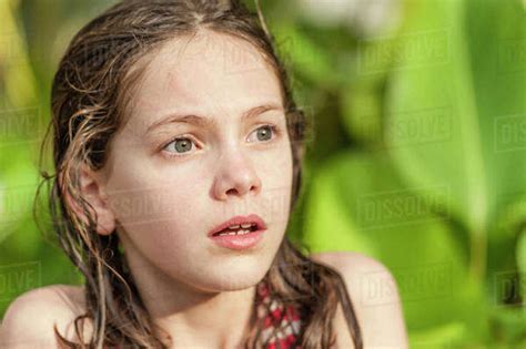 Girl with wet hair looking away with surprised expression on face - Stock Photo - Dissolve