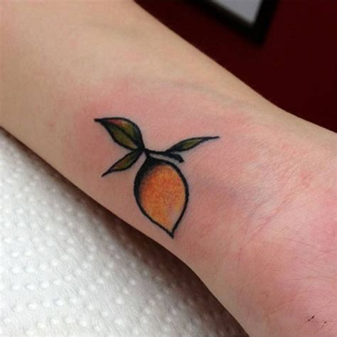 Wrist tattoo of a lemon by Kirk Nilsen. | Tattoos, Little tattoos, Tiny tattoos