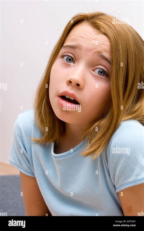 Portrait of a young girl being scared Stock Photo - Alamy