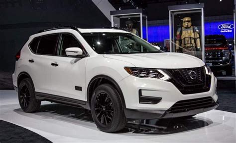 a white nissan suv is on display at an auto show