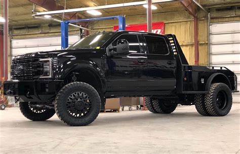 a large black truck parked in a garage