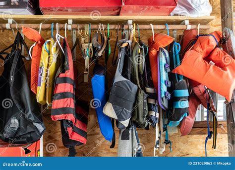 Variety of Life Jackets for Boating and Swimming Hanging in Storage in ...