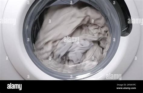 Washing clothes in a washing machine. Slow motion Stock Video Footage - Alamy