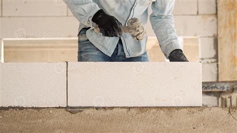 Construction workers are making white lightweight concrete blocks that ...