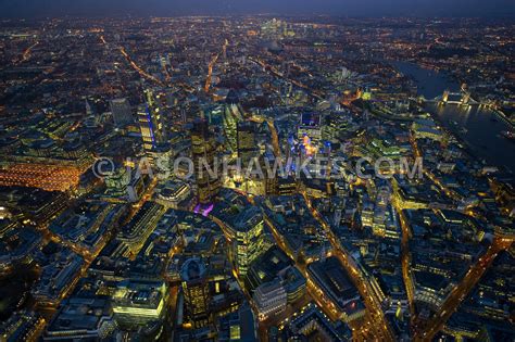 Aerial View. Aerial view over the City of London at night . Jason Hawkes