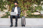 Afro tourist man using his laptop | People Images ~ Creative Market