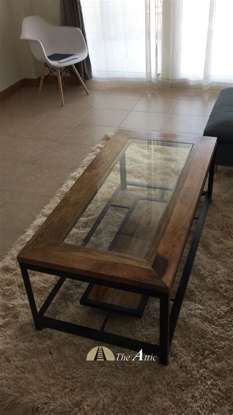 This coffee table is the perfect blend of wood, glass and metal with clean straight lines and ...