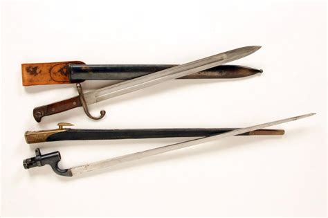 Lot of 2 Bayonets consisting of a British triangular bayonet with scabbard marked "WD", original sca