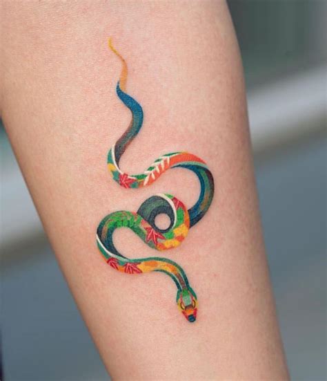 a colourful snake tattoo | Minimalist tattoo, Tattoo designs, Snake tattoo