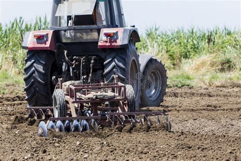 A Tractor Working Planting Wheat in the Fertile Farm Fields of G Stock ...