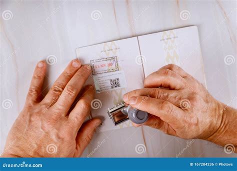 Border Control Officer Puts a Stamp in the Passport Page of Passport Stamps. Immigration Service ...