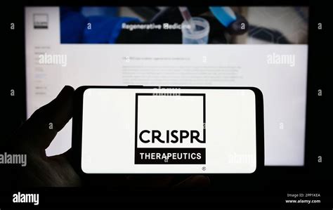 Person holding smartphone with logo of biotechnology company CRISPR ...