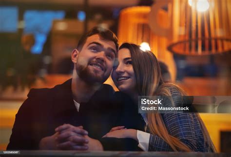 Beautiful Girl Hugs A Guy In A Cafe Stock Photo - Download Image Now ...