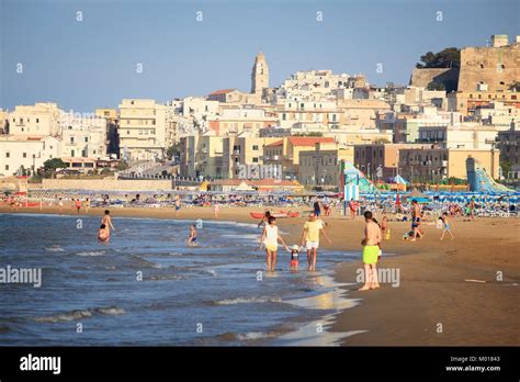 VIESTE, ITALY - JUNE 5, 2017: People visit a beach in Vieste. Italy is one of most visited ...