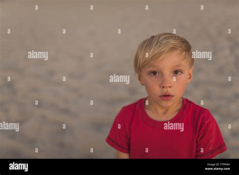 Portrait of boy standing at beach Stock Photo - Alamy