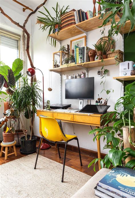 Cozy Home Office with focus on green plants with wall shelves and a poppy yellow desk chair ...