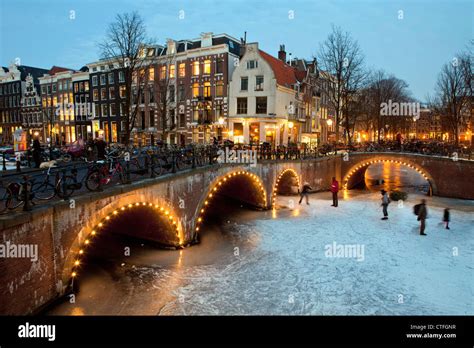 The Netherlands, Amsterdam, Winter, ice skating on frozen canals ...